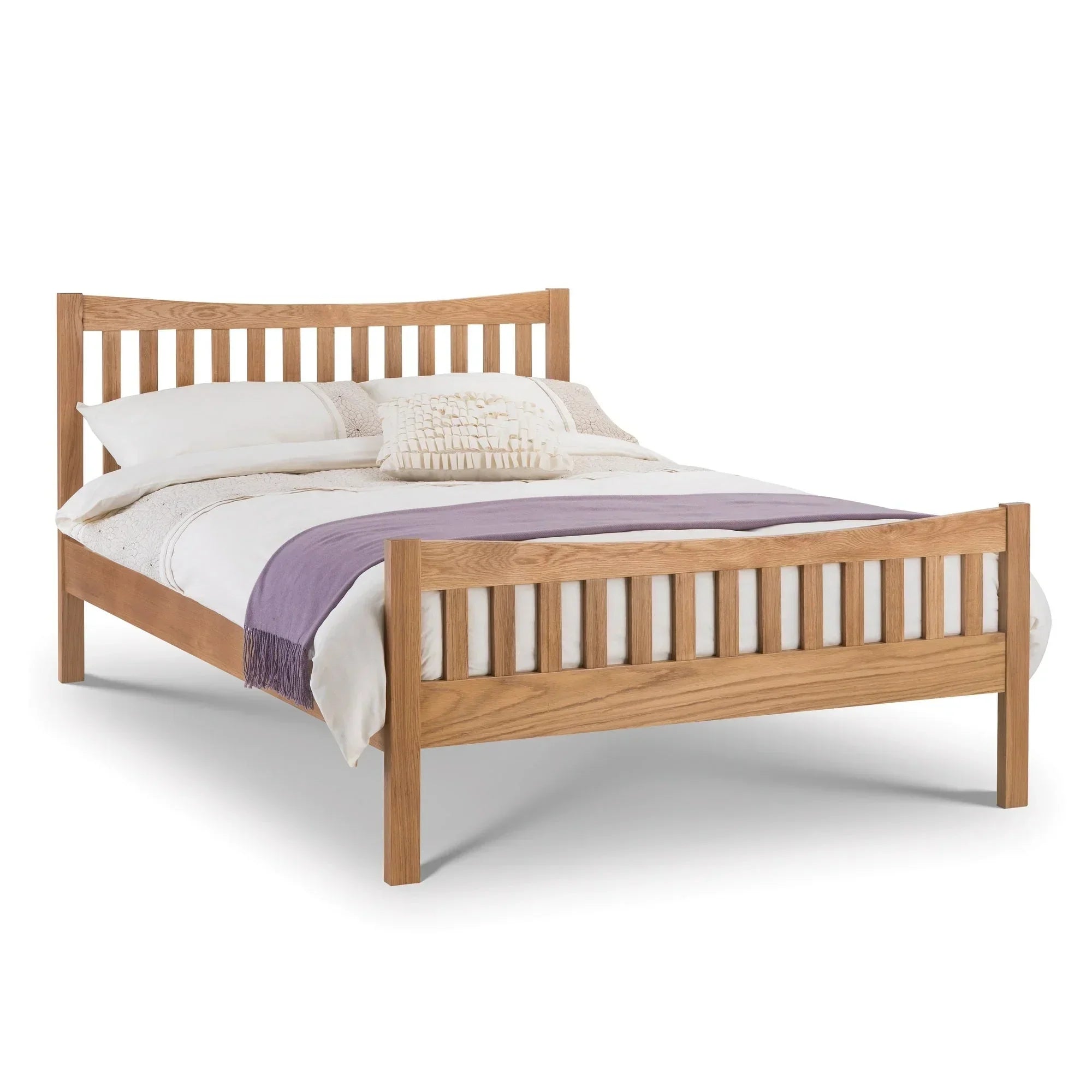 Oak double bed frame with slatted headboard and footboard, dressed in cream bedding