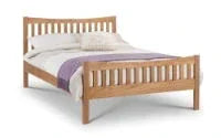 Oak wooden bed frame with slatted headboard and footboard, dressed with white bedding