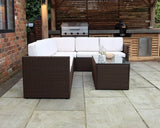 Brown rattan garden sofa set with white cushions and glass coffee table on patio