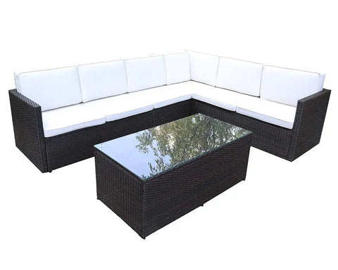 Brown rattan garden sofa set with white cushions and glass top coffee table