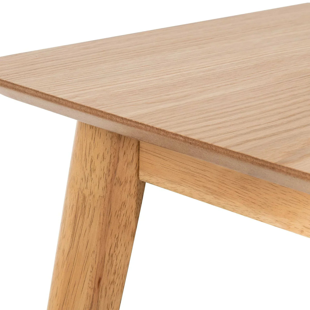 Close-up of rectangular oak dining table corner with wood grain detail