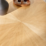 Close-up of light wood dining table surface showing radial wood grain pattern