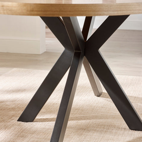 Close-up of intersecting matte black metal legs forming sturdy geometric base