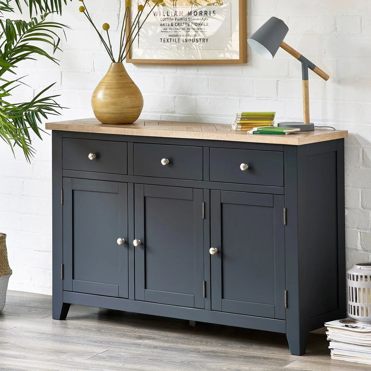 Dark blue sideboard with three drawers and wood top in modern living room setting