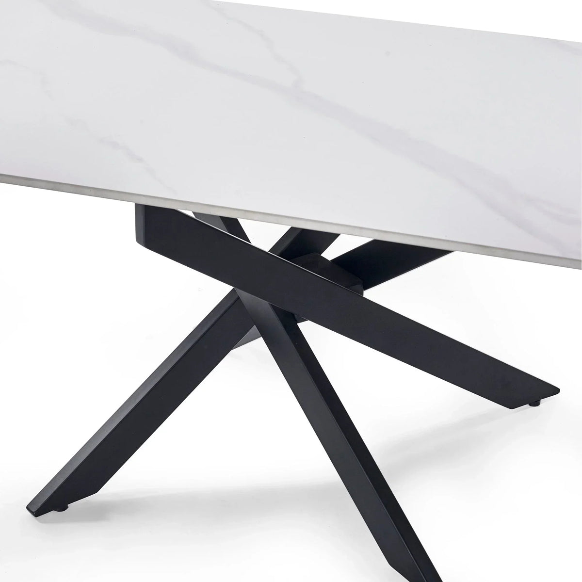 White marble coffee table with black metal crossed legs, close-up of tabletop and base