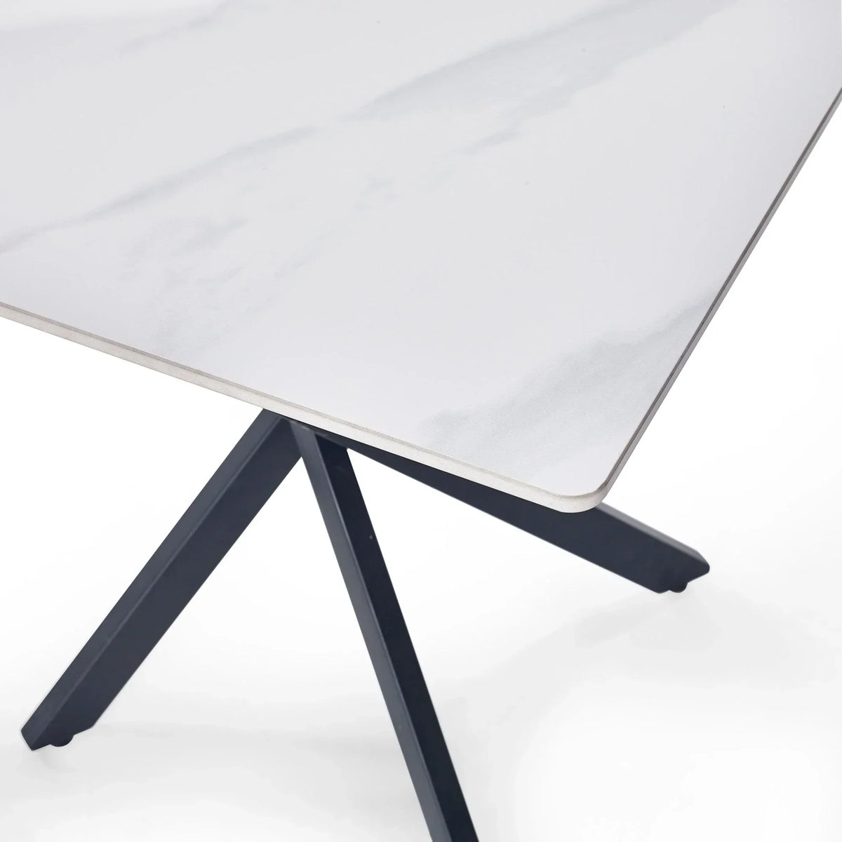 White marble lamp table with black angled legs, close-up on tabletop corner and base