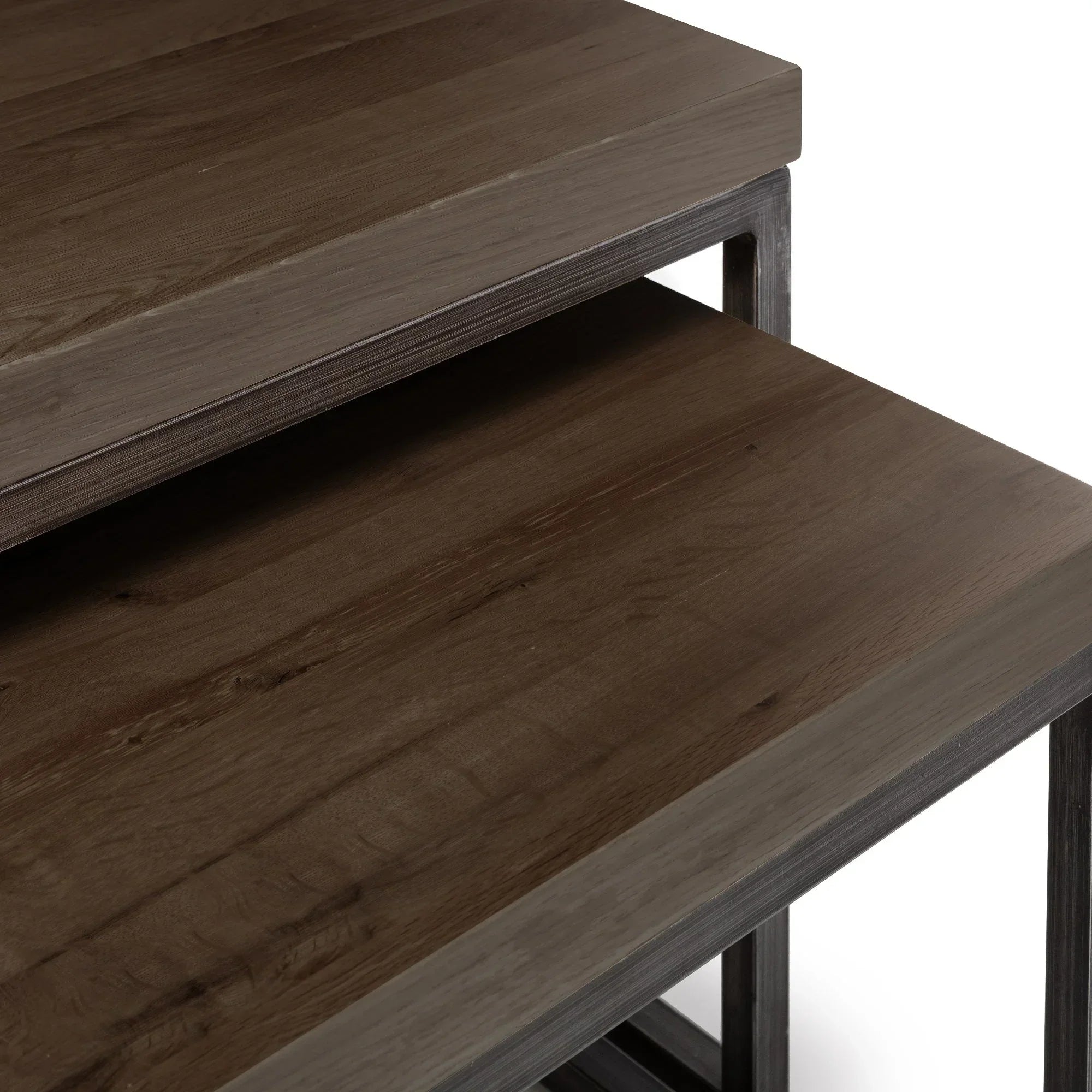 Dark oak nesting coffee tables with metal frame, closeup of wood grain and table edges