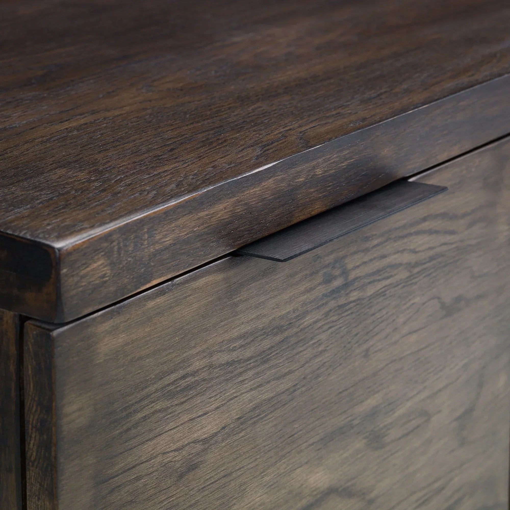Close-up of dark oak TV unit showing wood grain texture and integrated handle detail