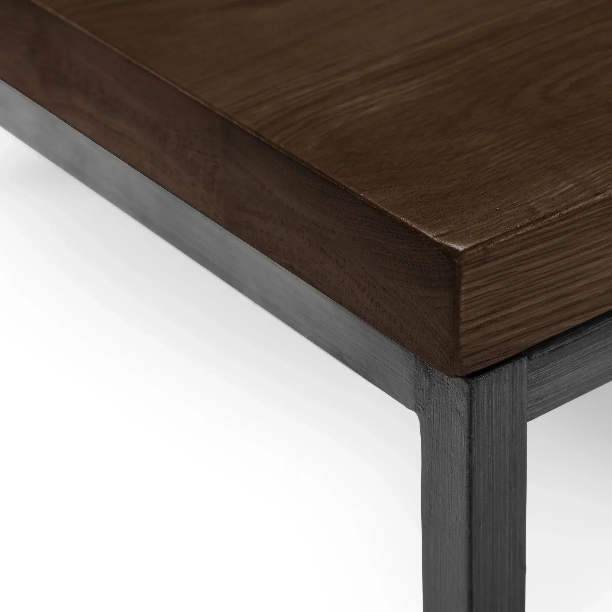 Dark oak coffee table corner with metal legs and wood grain detail