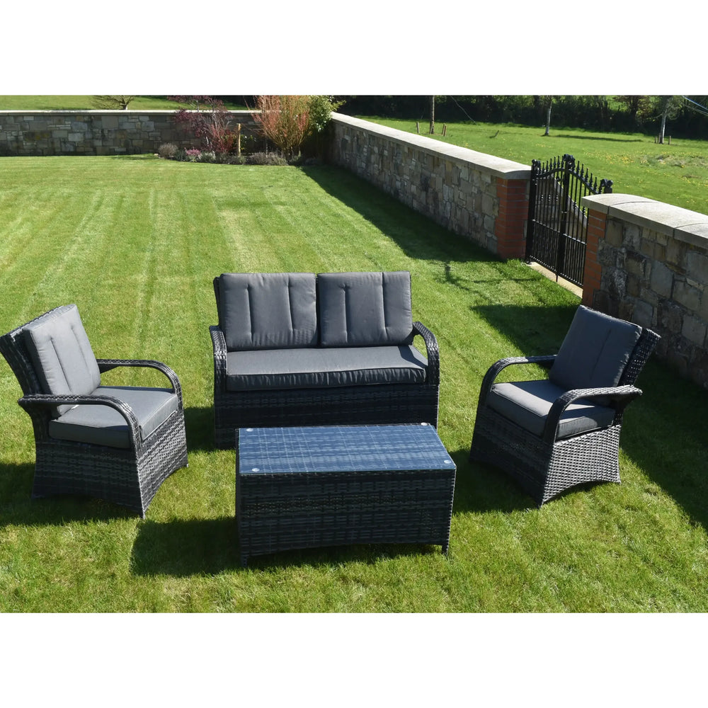 Grey rattan outdoor sofa set with cushioned chairs and coffee table on lawn