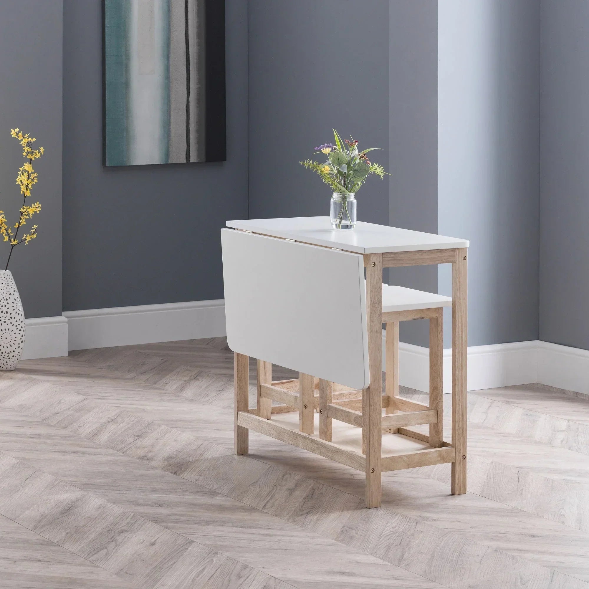 White and oak folding bar set with stools in a modern dining room corner