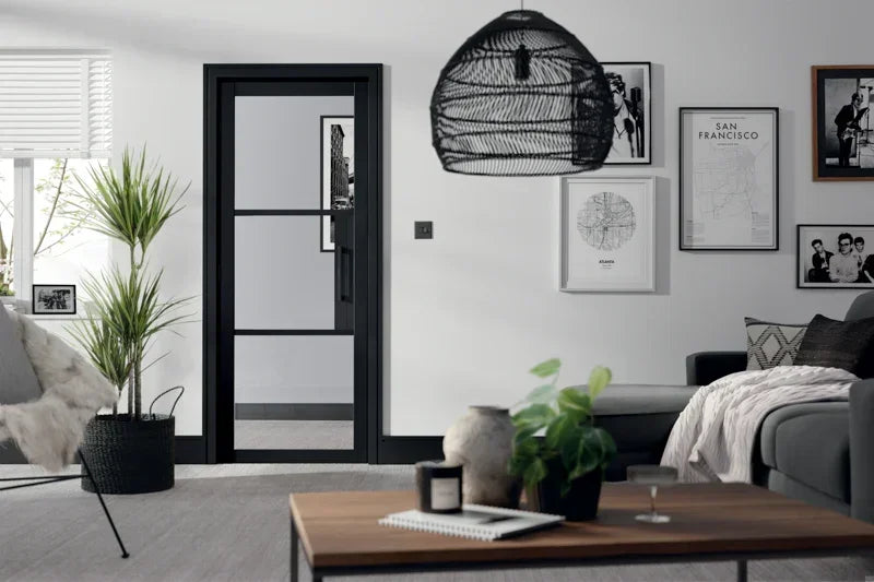 Black glazed Tribeca 3L internal door in modern living room with grey sofa and wall art