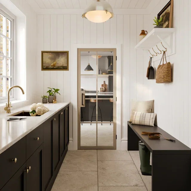 Blonde Oak flooring in a bright entryway with black cabinets and bench seating