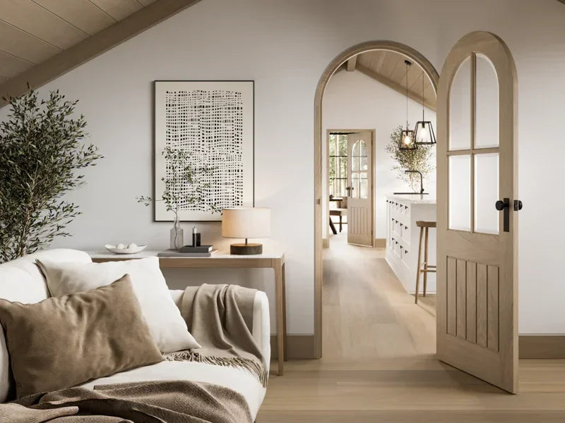Blonde oak Mexicano arched glazed door in modern living room opening to kitchen