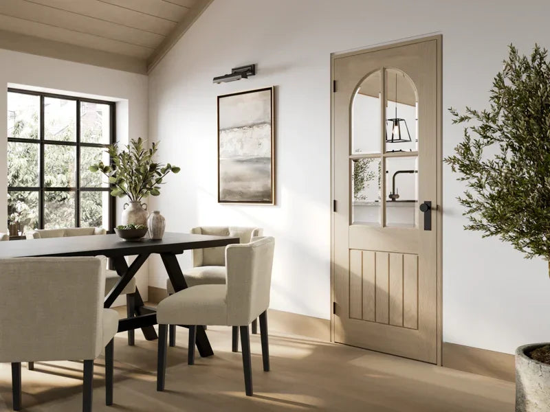 Blonde oak Mexicano arched glazed door in modern dining room with cream chairs