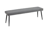 Grey low bench with quilted fabric seat and black tapered legs, side angle view