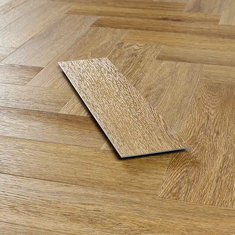 Brushed oak wood flooring sample on herringbone pattern floor, close-up view