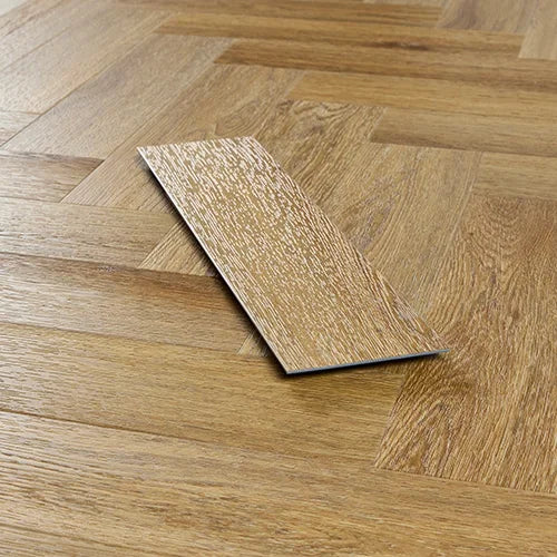 Brushed oak wood flooring sample on herringbone pattern floor, close-up view
