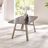 Rectangular glass dining table with textured top and metal legs in bright modern room