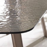 Closeup of textured glass garden table top with metal legs on tiled floor
