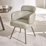 Modern beige leather dining chair with padded backrest and metal legs on tiled floor