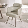 Modern beige leather dining chair with padded backrest and metal legs on tiled floor
