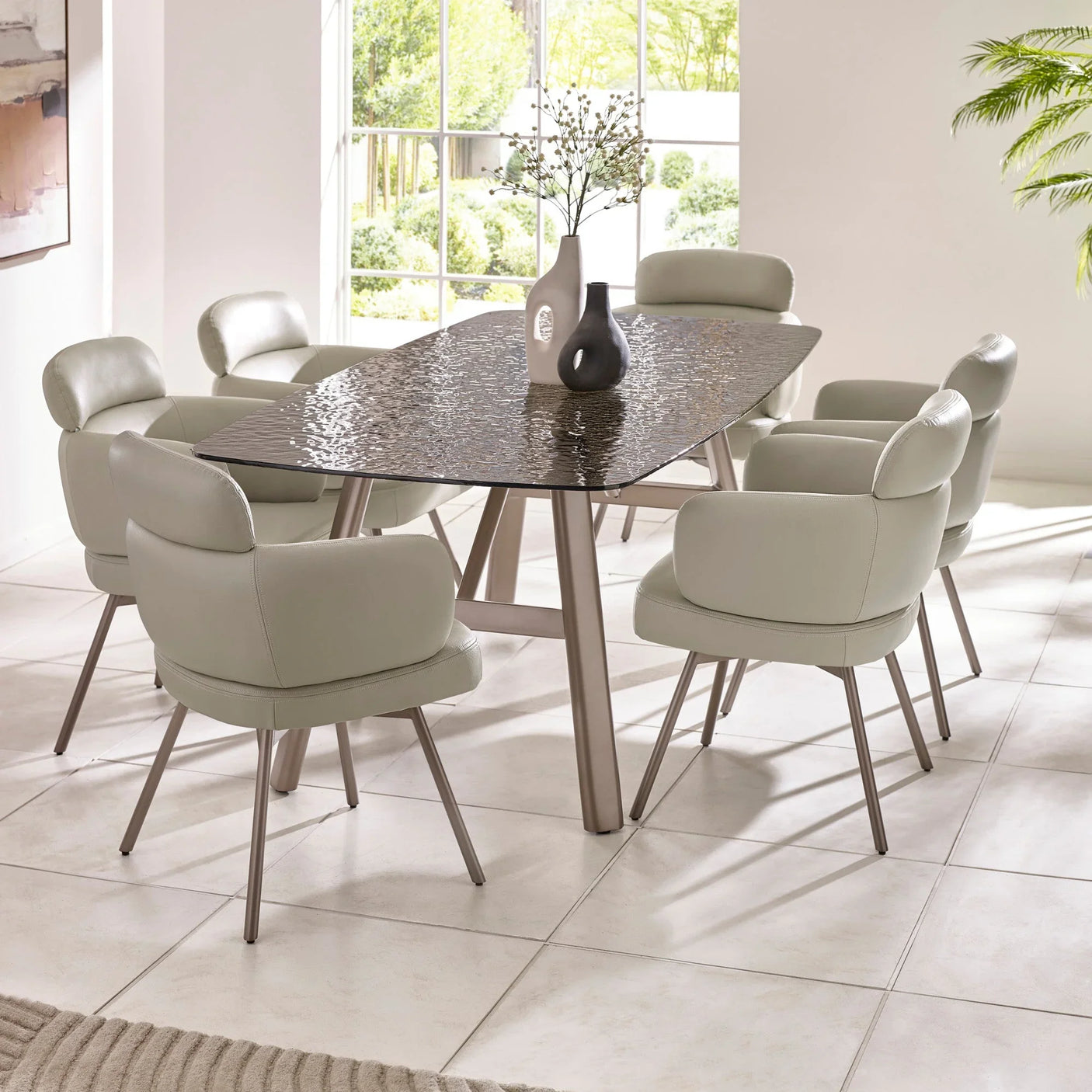 Modern dining table with textured glass top and six beige upholstered dining chairs