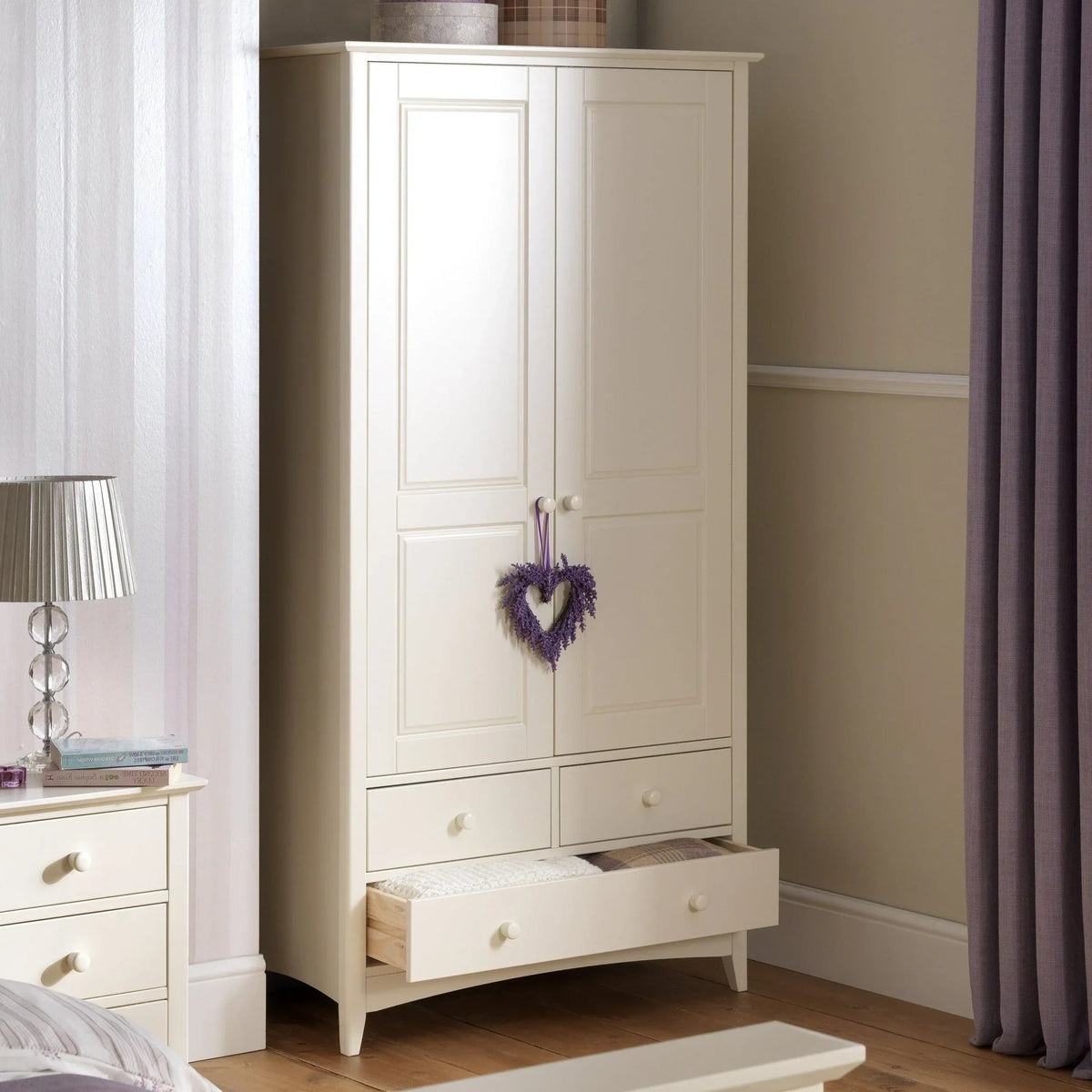 Stone white combination wardrobe with four drawers, heart decoration, in a modern bedroom