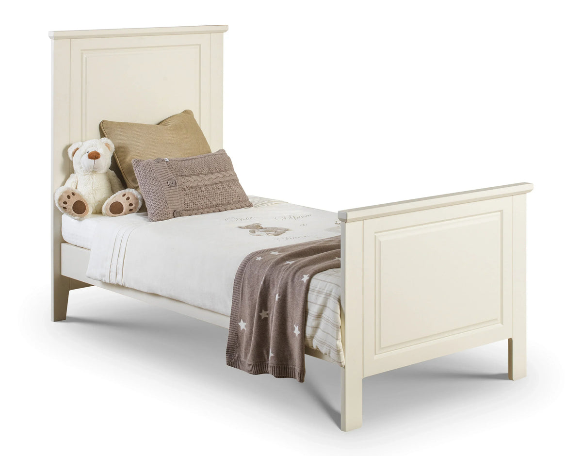 Cream cameo cot bed with panelled headboard, soft bedding, throw and teddy bear