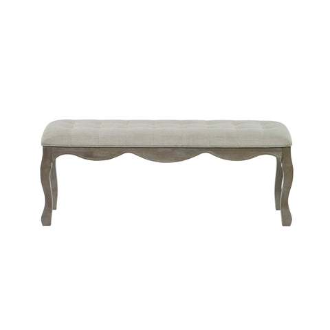 Front view of bench with light beige tufted fabric seat and natural wooden frame with wavy apron