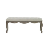 Front view of bench with light beige tufted fabric seat and natural wooden frame with wavy apron