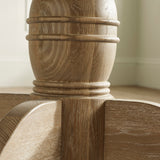 Close-up of light oak round table pedestal base with carved detailing and grain texture