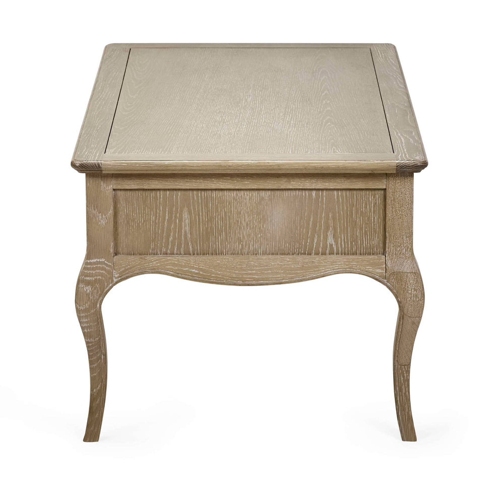 The Camille French Style Rectangular Coffee Table features a limed oak finish with elegant curved legs and a smooth top, perfect for adding a touch of sophistication to any living room setting
