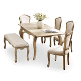 The Camille French Style Rectangular Extending Dining Table in limed oak features elegantly curved legs, paired with upholstered chairs and a tufted bench, creating a sophisticated dining setting perfect for 4 to 6 people