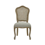 Front view of beige rattan dining chair with carved light wood frame on white background
