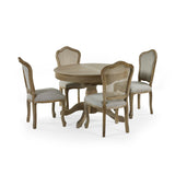 Round wooden dining table with four beige dining chairs, two with cane backs, on white background.