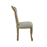 Side profile of beige upholstered dining chair with curved wooden legs and frame