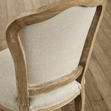 Close-up of beige upholstered backrest with wooden frame on dining chair showing fabric texture and finish.