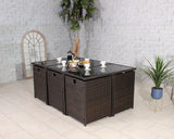 Brown rattan garden dining table set with glass top, cups, and snacks in a tiled room