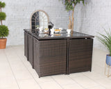Brown rattan dining set with glass top table arranged for breakfast in modern tiled room