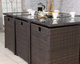 Brown rattan garden dining table set with glass top and breakfast items displayed