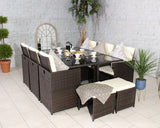 Brown rattan dining set with glass table, cushioned chairs, bench and neutral decor