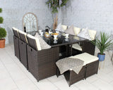 Brown rattan garden dining set with glass table, cushioned seats, and pillows on patio