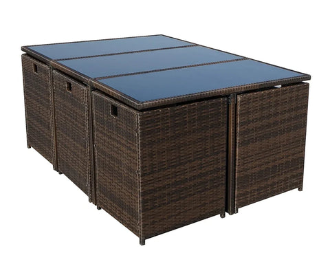 Brown rattan outdoor dining table with glass top and cube storage stools underneath