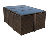 Brown rattan outdoor dining table with glass top and cube storage stools underneath