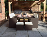Brown rattan garden dining set with cream cushions arranged under wooden pergola