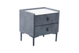 A modern two-drawer nightstand with a dark gray velvet upholstered frame, a white top surface, and slim dark legs, shown on a plain white background.