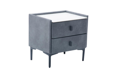 A modern two-drawer nightstand with a dark gray velvet upholstered frame, a white top surface, and slim dark legs, shown on a plain white background.