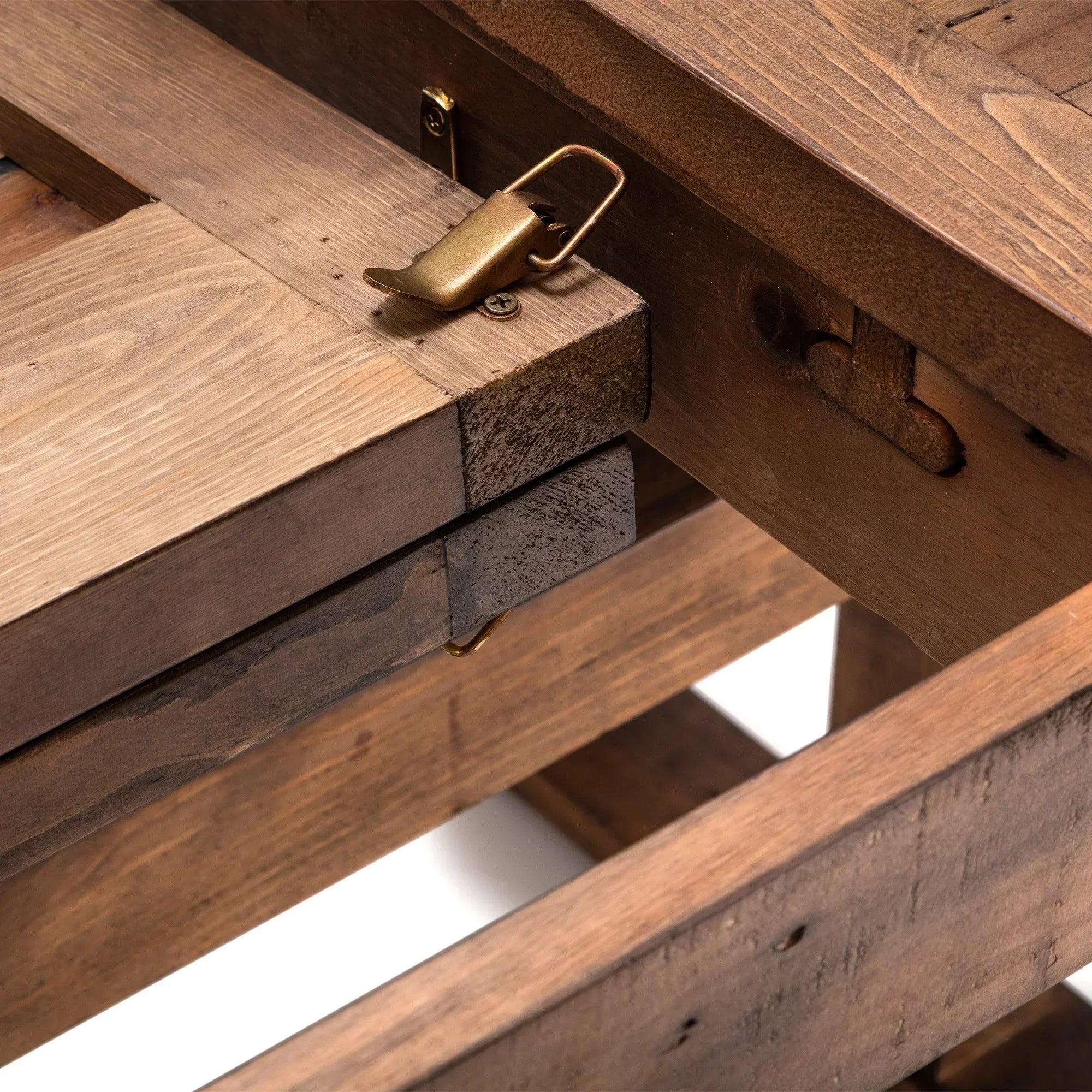 Solid wood extending dining table closeup showing metal latch and joinery detail