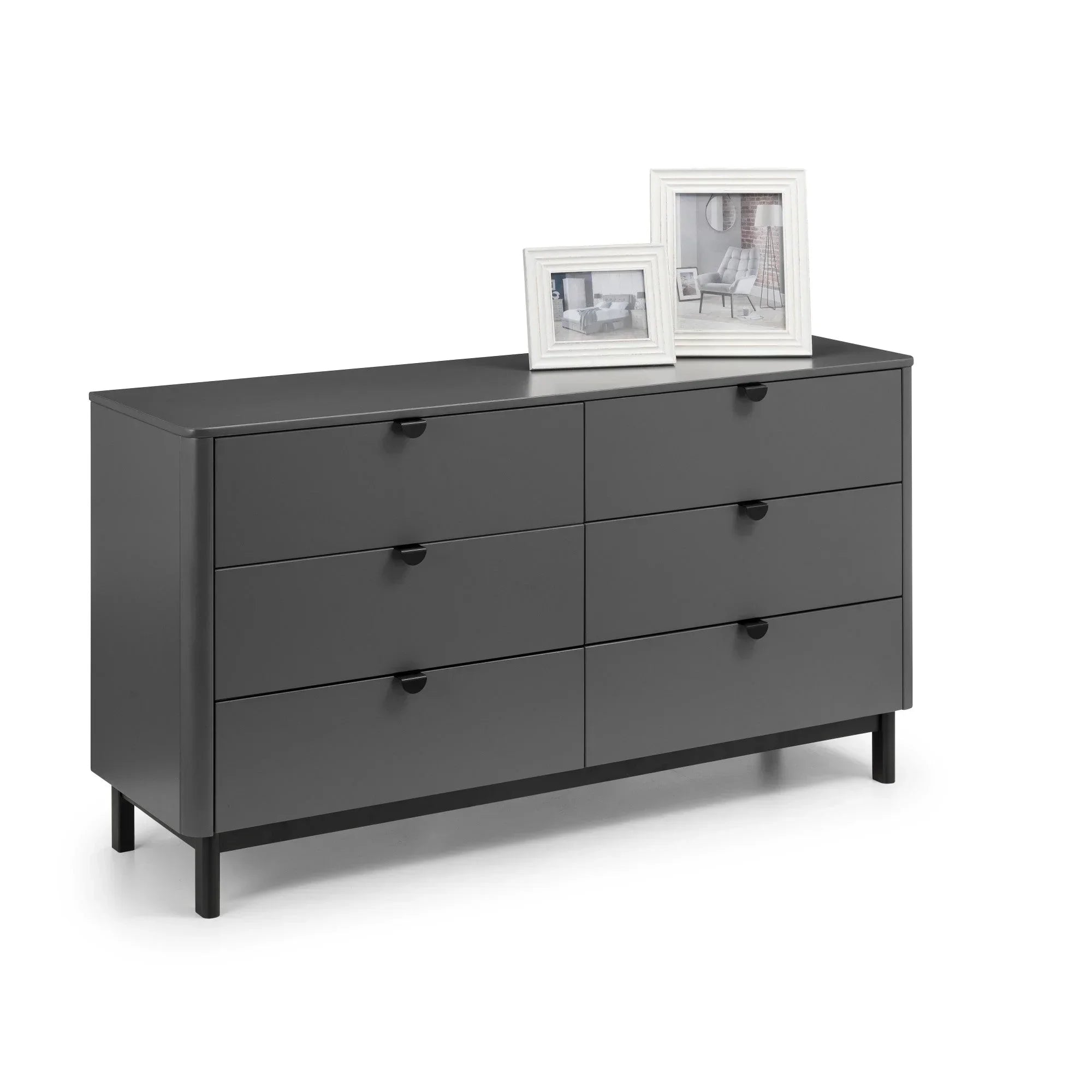 Black six drawer chest with minimalist handles, featuring two photo frames on top